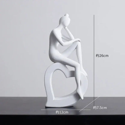 Minimalist white ceramic abstract figures sculpture of a seated woman on a heart-shaped base for living room decor