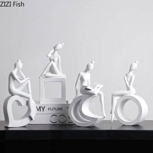 Minimalist white resin abstract figures sculpture featuring stylized women on geometric bases for living room decor