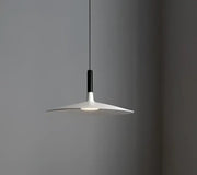 Minimalist white and black glass pendant light with a sleek disc-shaped shade for bedroom use