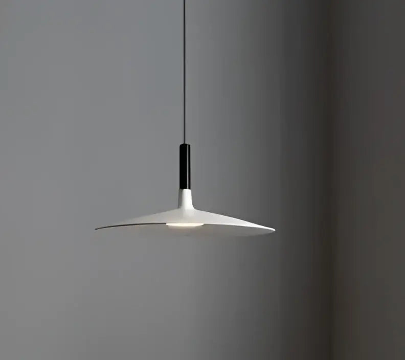 Minimalist white and black glass pendant light with a sleek disc-shaped shade for bedroom use
