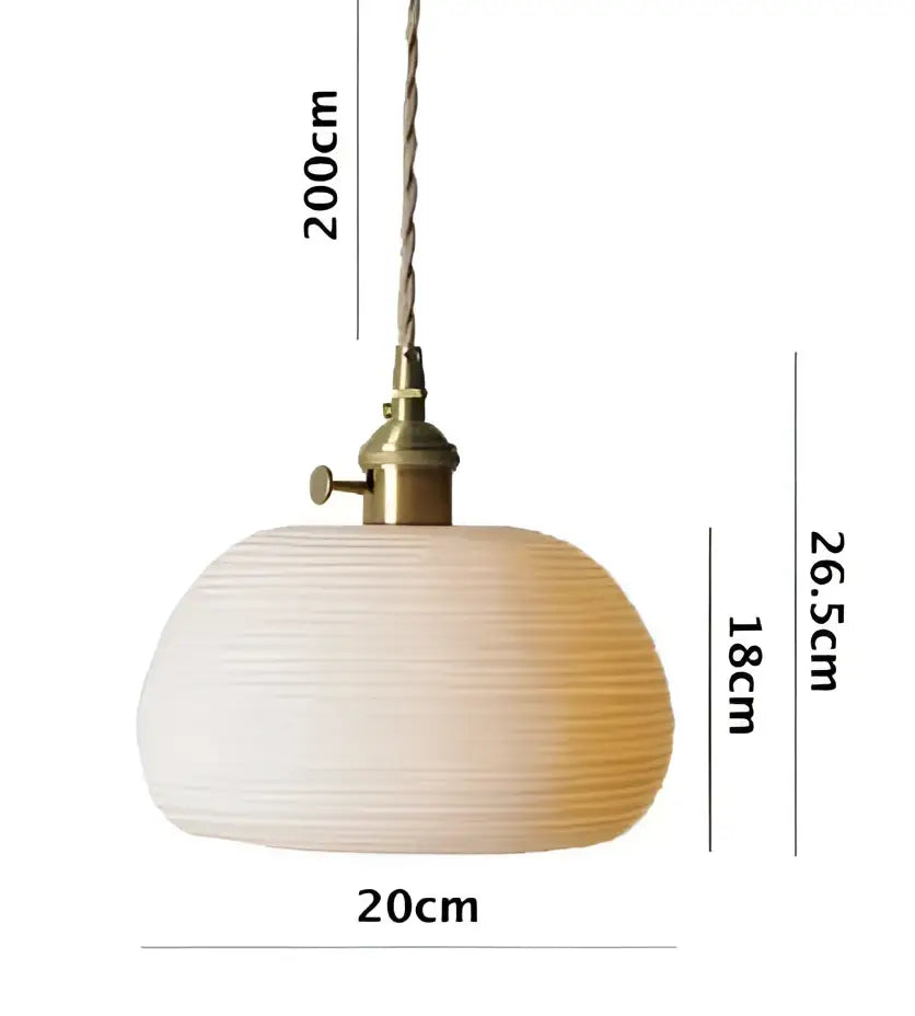 A warm-toned ribbed paper pendant light with brass fixture and twisted cord for minimalist bedroom glass pendant light