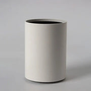 Minimalist white cylindrical wastebasket with matte finish and black interior complements decorbites led ceiling light