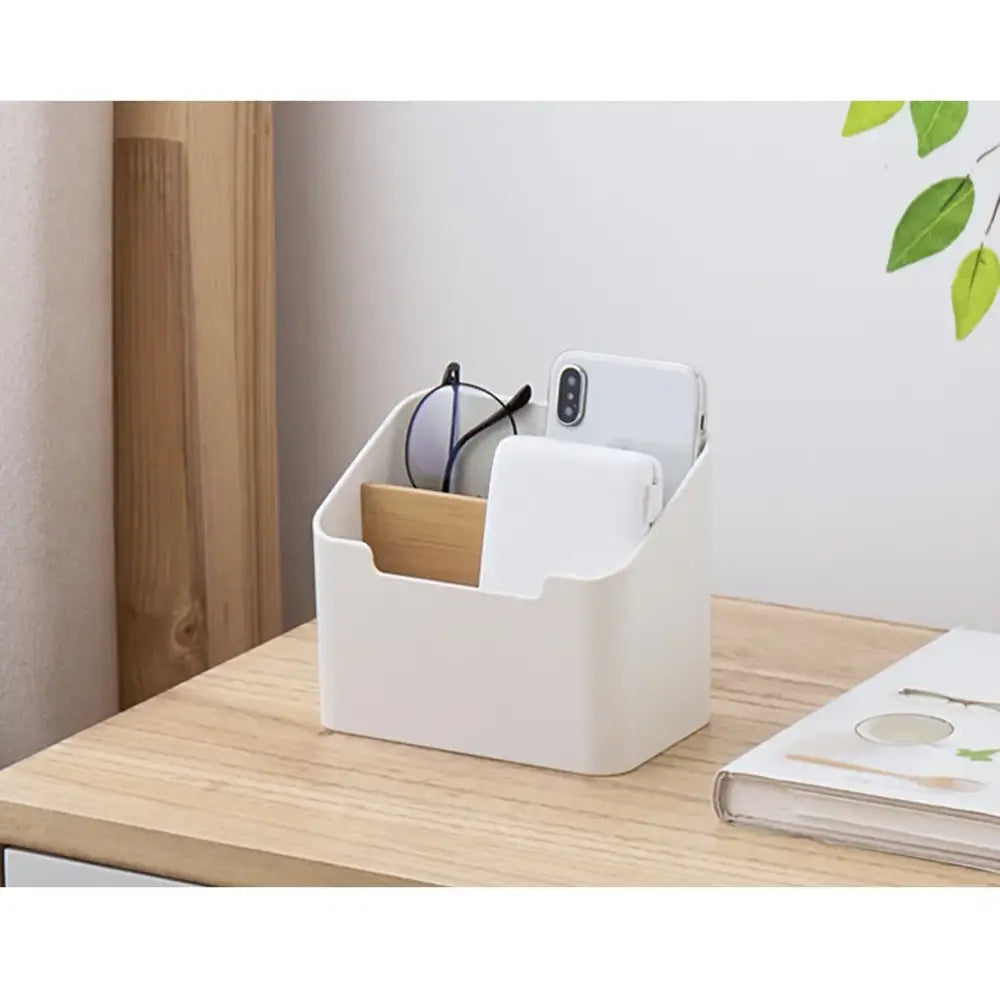 Minimalist white plastic and wood storage rack with multiple compartments for office supplies and phone organization