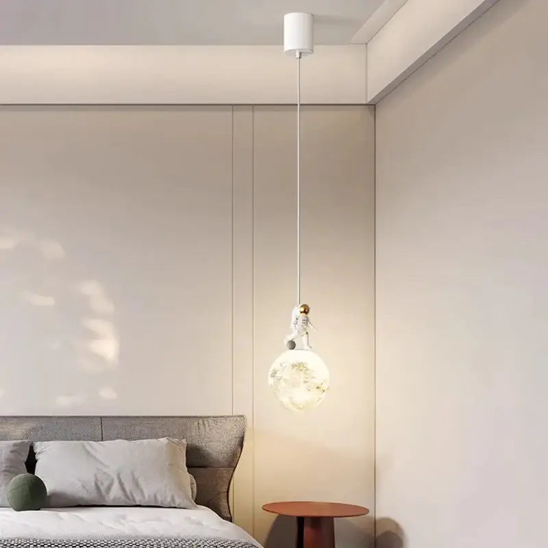 Minimalist white astronaut pendant light with a spherical glass globe decorbites astronaut pendant for children’s bedroom