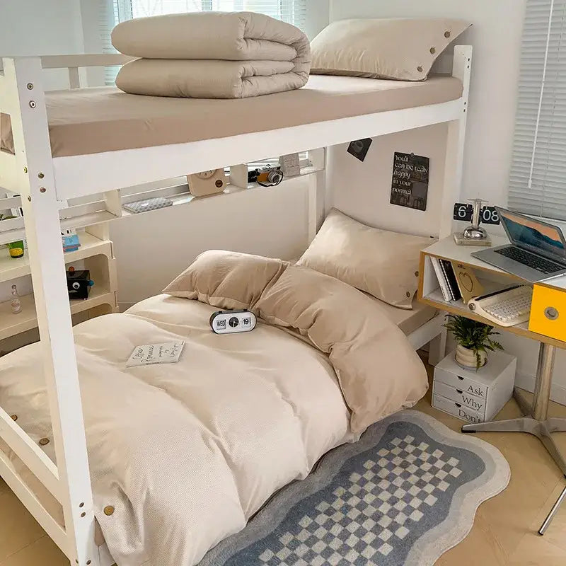 White bunk bed with beige decorbites buttoned washed cotton bedding set and wooden nightstand in minimalist bedroom