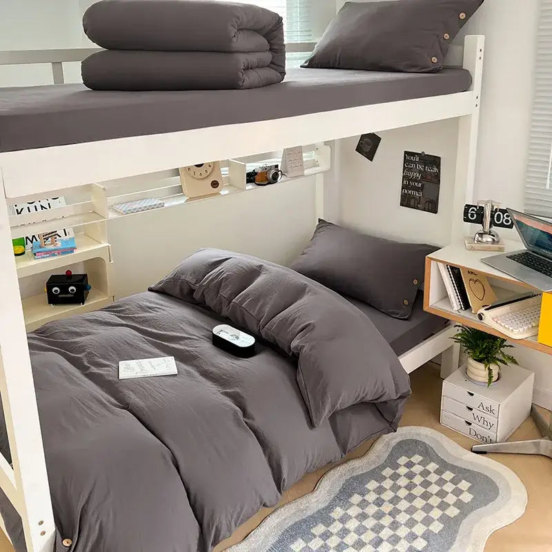 Gray bedding set with decorbites buttoned washed cotton duvet and matching pillows on a minimalist bunk bed