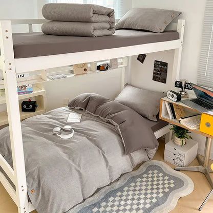 Gray striped bedding set with matching pillowcases and folded blanket on top bunk made of decorbites buttoned washed cotton