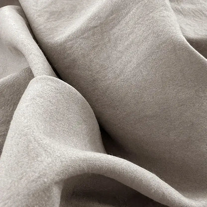 Soft heather gray knit fabric with subtle texture and folds in minimalist white buttoned washed cotton bedding set decorbites
