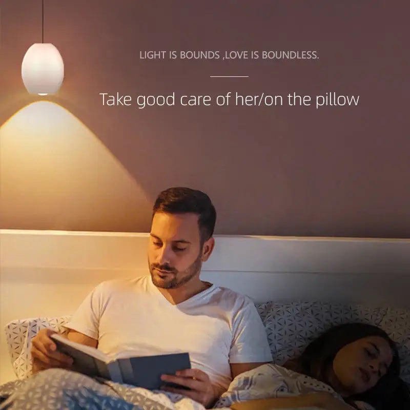 Minimalist white ceramic egg decorbites adjustable pendant light with warm white rounded glass shade above bed