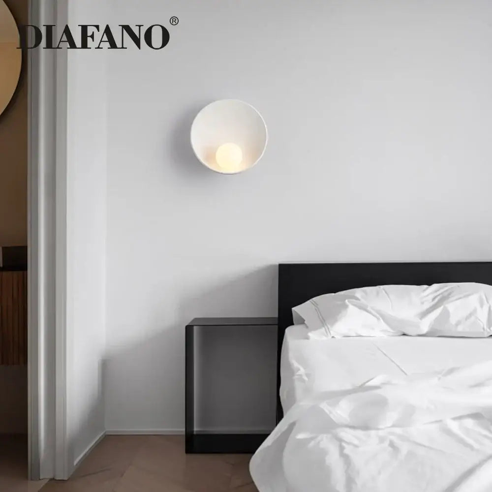 Minimalist white ceramic led wall sconce with a bowl-shaped design for bedroom lighting and decor