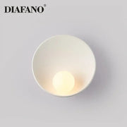 Minimalist white ceramic led wall sconce by diafano with smooth bowl design and integrated warm-toned led bulb for bedroom lighting