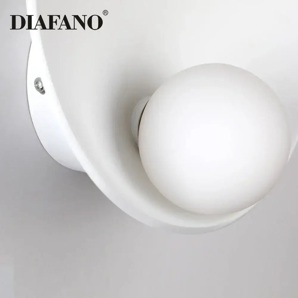 Minimalist white ceramic led wall sconce with frosted glass globe and curved housing for bedroom lighting