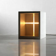 Minimalist white concrete church table lamp with black frame and warm glowing cross light for bedroom night decorbites concrete church