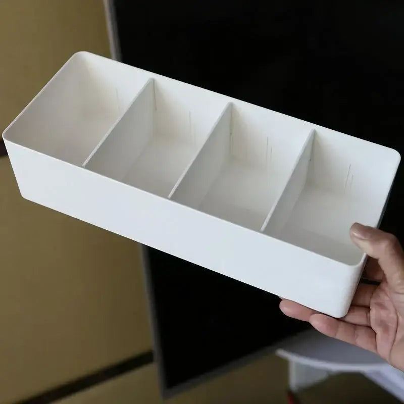 White rectangular plastic divided storage box with three compartments for minimalist kitchen tableware organization