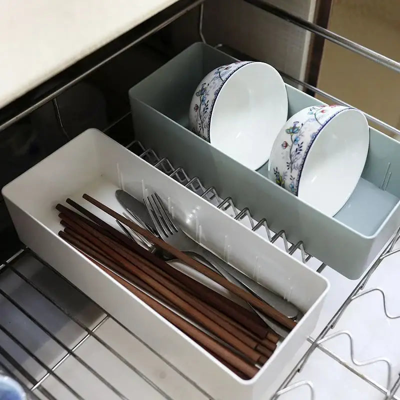 Minimalist white plastic divided storage box with compartments for chopsticks, forks, and decorative bowls for kitchen organization