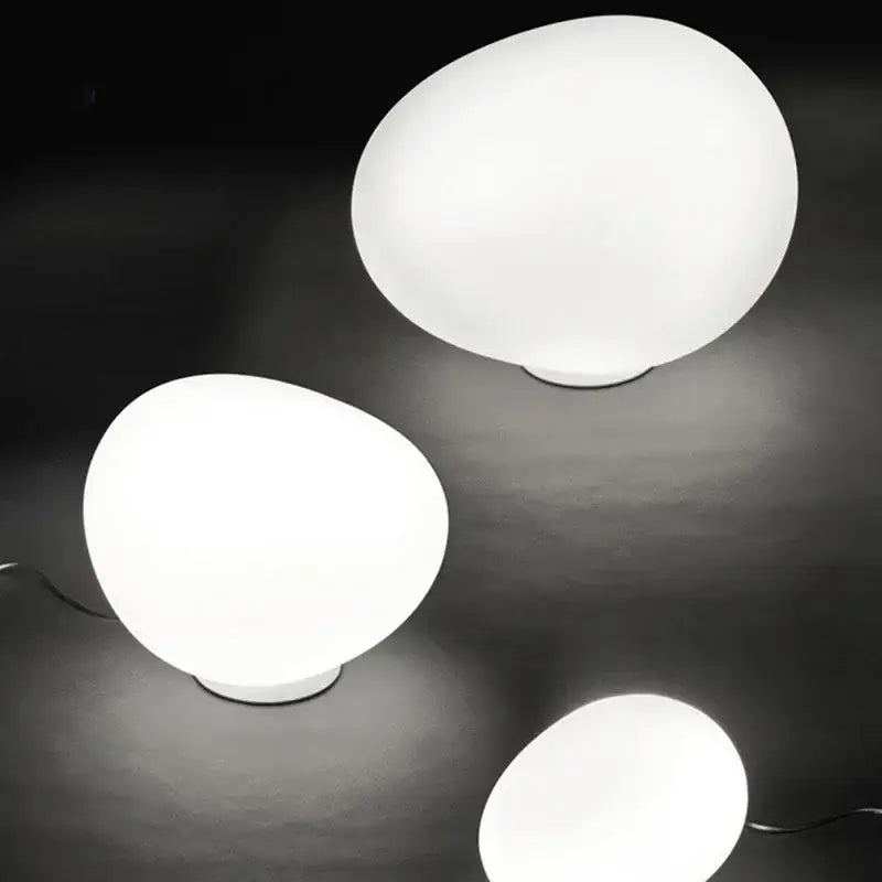 Minimalist white egg glass floor lamp with smooth matte finish designed for modern living room lighting