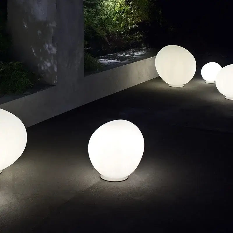Minimalist white spherical glass floor lamp with smooth matte finish for living room use