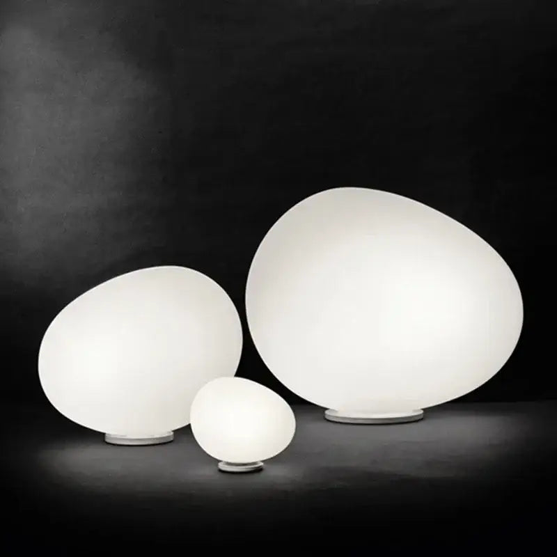 Minimalist white egg glass floor lamp with frosted glass shades and metallic bases for living room use