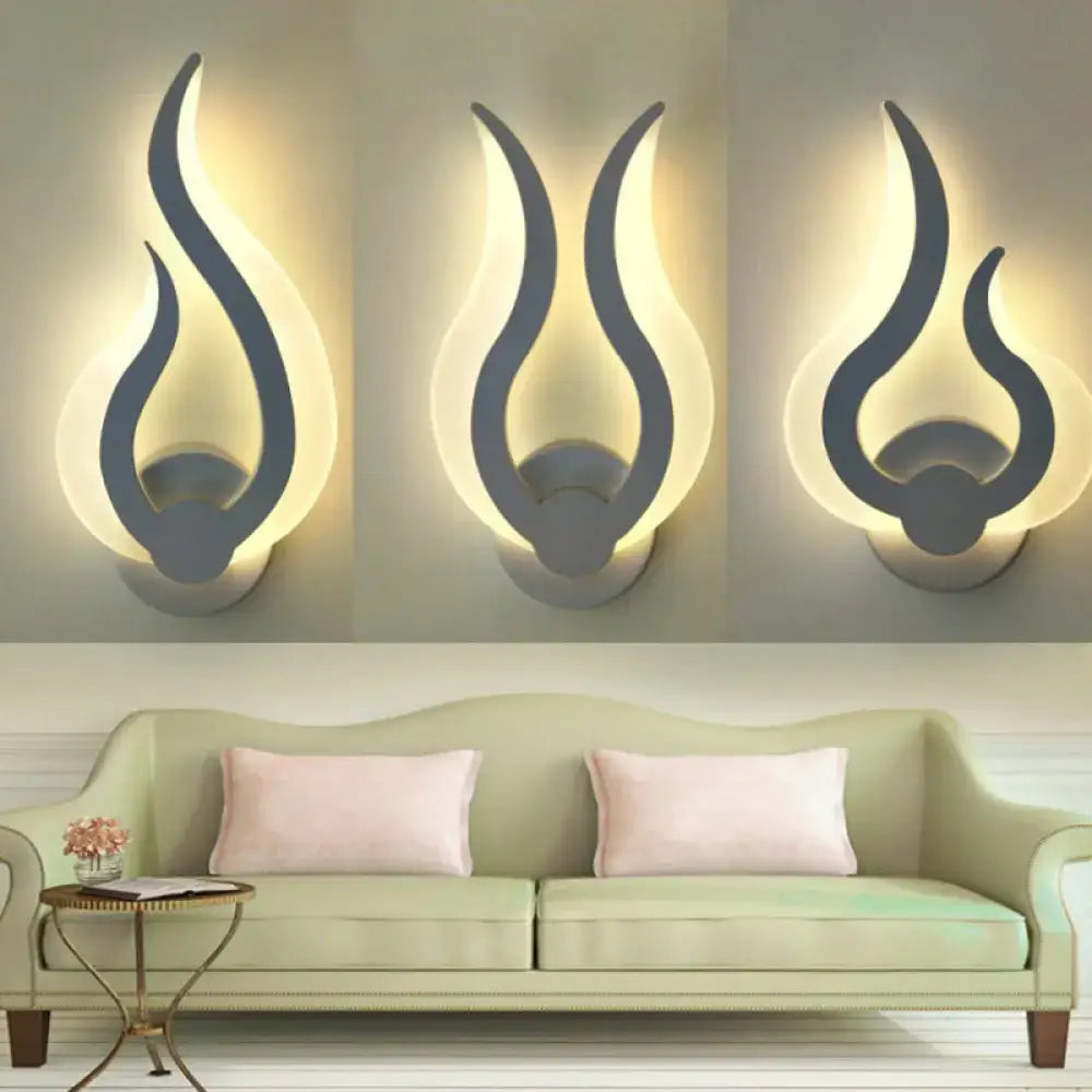 Minimalist white flame wall sconces with a sleek gray finish and warm glowing LED light for bedroom use