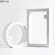Minimalist white geometric circle desk ornament featuring a circular ring and rectangular frame with spherical elements