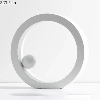 Minimalist white geometric circle desk ornament with a spherical element for modern office decor by decorbites geometric circle