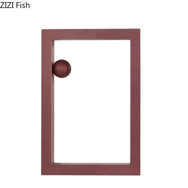 Maroon rectangular frame with matching spherical knob as minimalist decorbites geometric circle desk ornament in office decor
