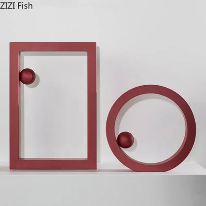 Red minimalist geometric circle desk ornament featuring rectangular frame and ring holding matching spheres for decorbites decor