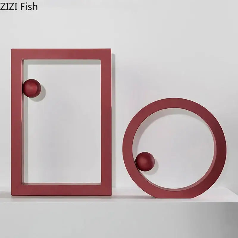 Red minimalist geometric circle desk ornament featuring rectangular frame and ring holding matching spheres for decorbites decor