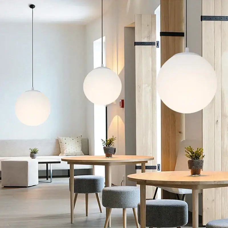 Minimalist white glass ball pendant lights with frosted finish hanging from ceiling for dining room decorbites glass ball pendant
