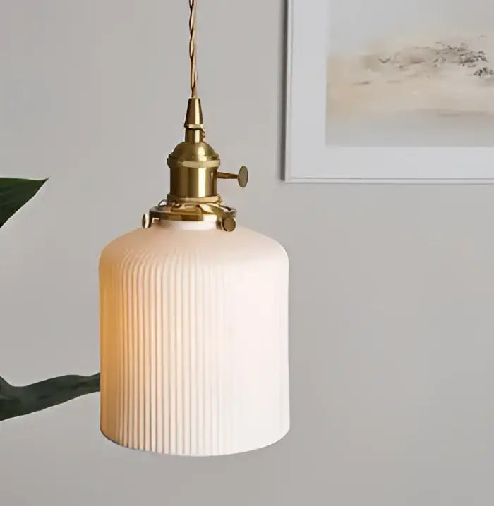 Minimalist white ribbed glass pendant light with brass-finished metal fixture ideal for dining room pendant lights