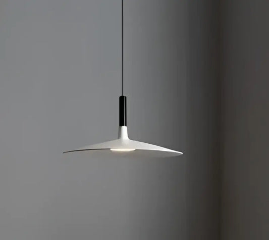 Minimalist white glass pendant light with sleek disc-shaped shade and black stem ideal for dining room pendant lights