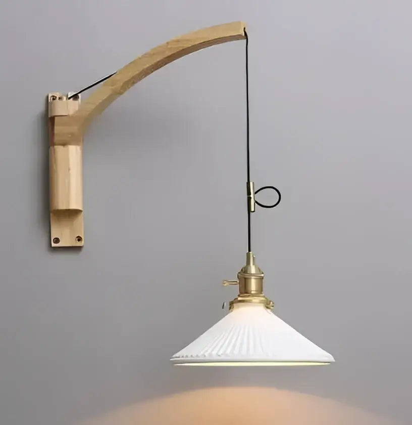 Minimalist white glass pendant light with curved wooden arm and brass hardware featuring a ribbed glass pendant shade