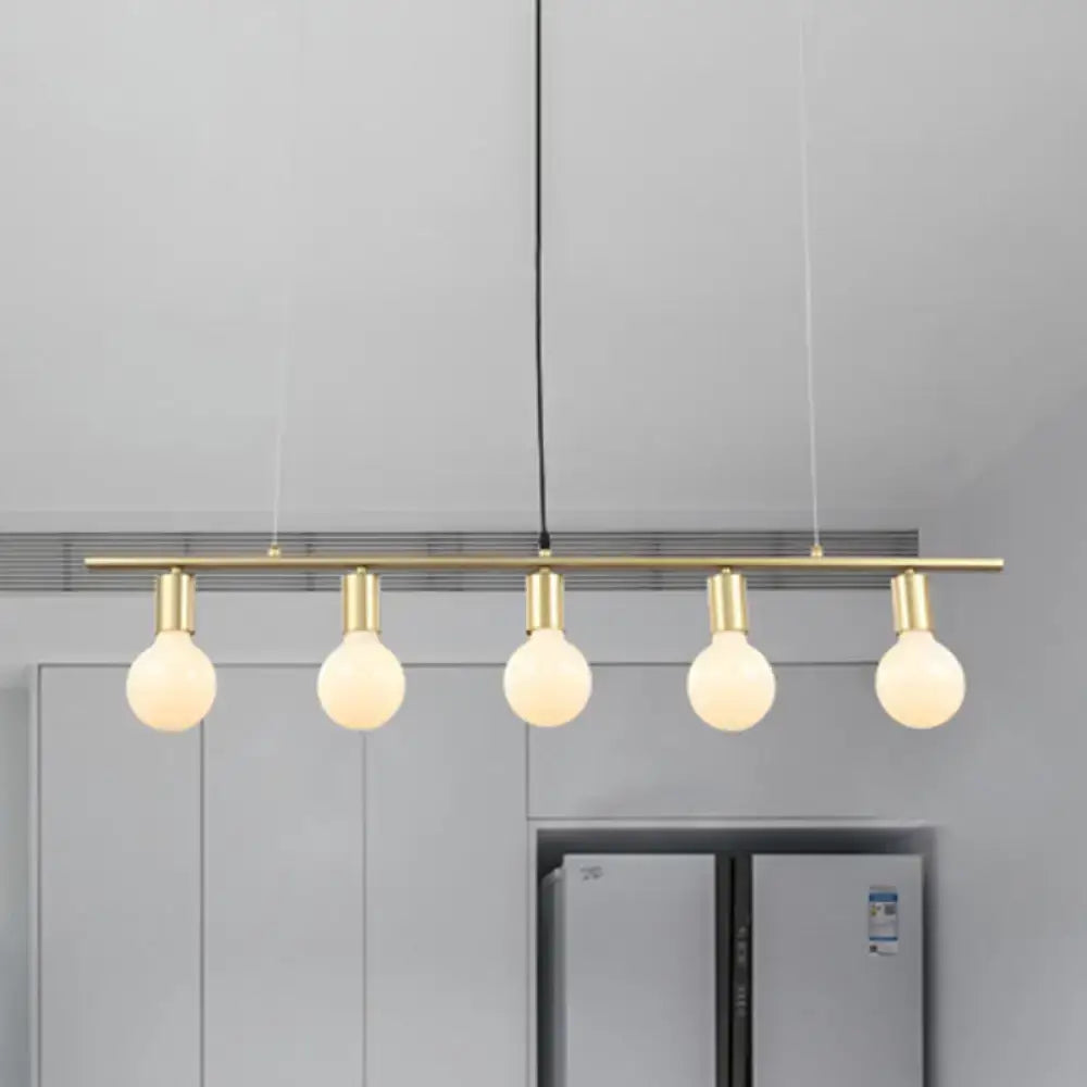 Modern white gold linear metal island lighting featuring a brass bar pendant light with five glowing spherical bulbs