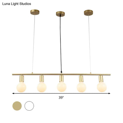 Modern brass pendant light fixture with five exposed globe bulbs and white gold linear metal island lighting design
