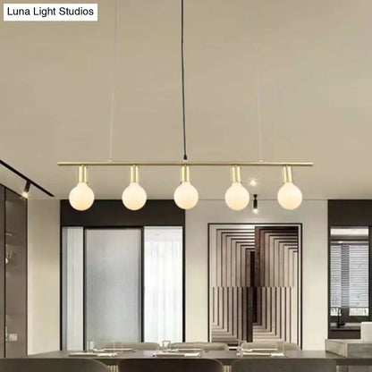 Modern brass bar pendant light with five frosted glass globes for minimalist white gold linear metal island lighting