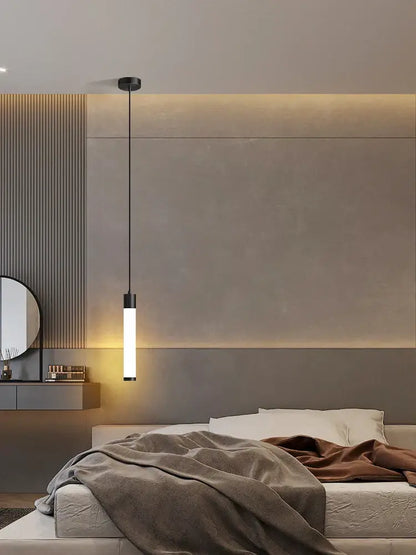 A sleek linear pendant light with black metal fixture and white finish translucent glass tube for kitchen island lighting