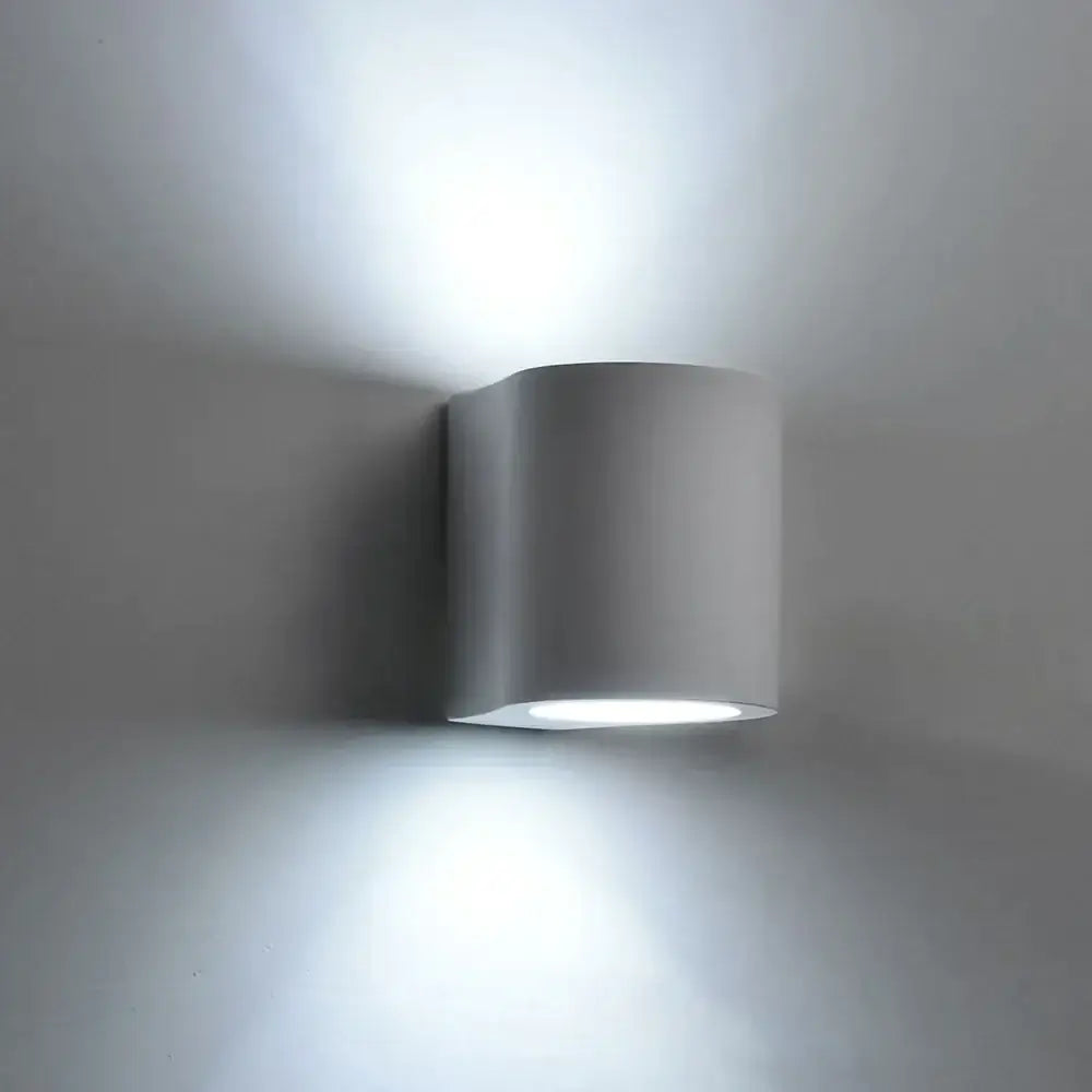 Modern white cylindrical gypsum wall lamp with sleek minimalist design providing diffused light for living room