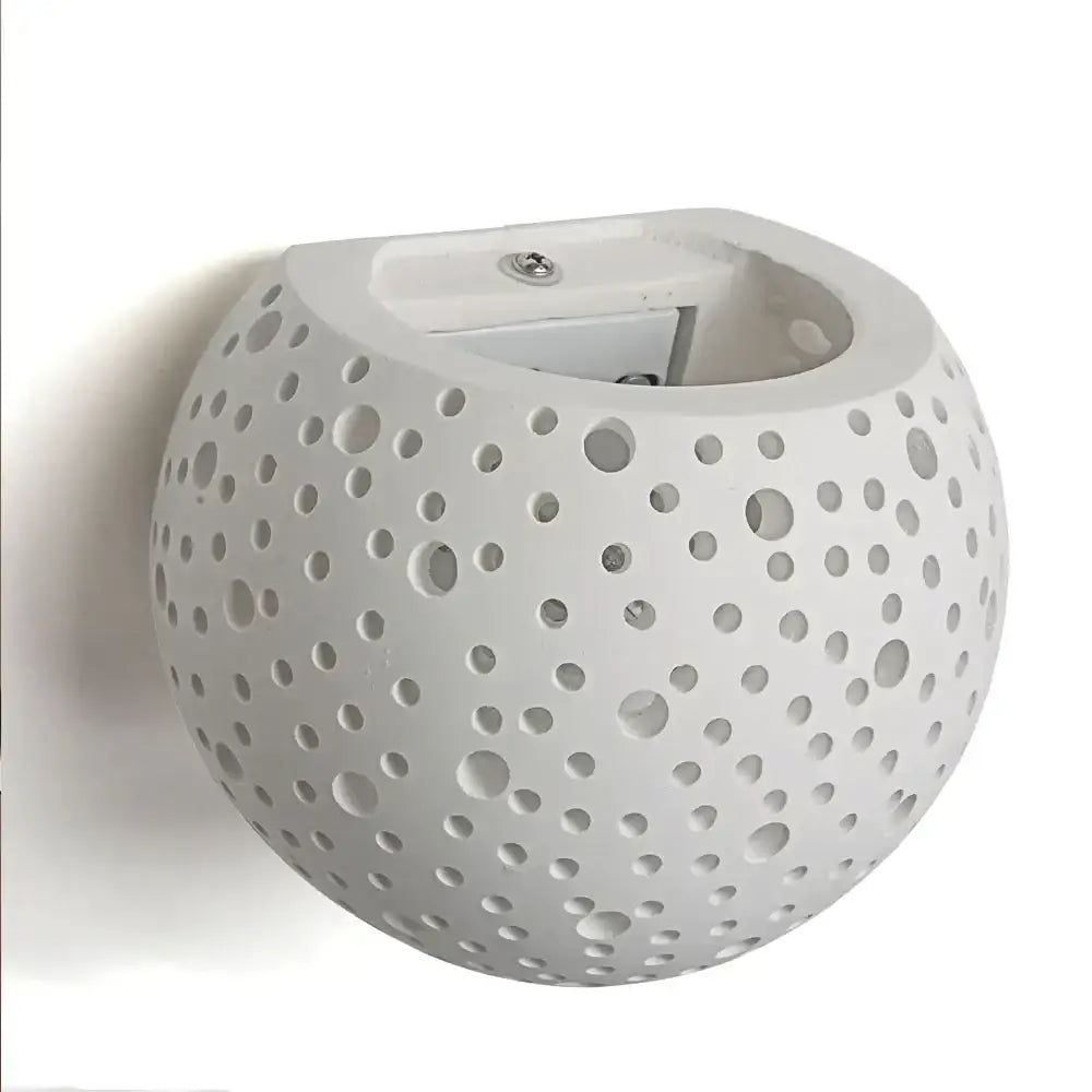 Minimalist white spherical gypsum wall lamp with perforated design for diffused living room light