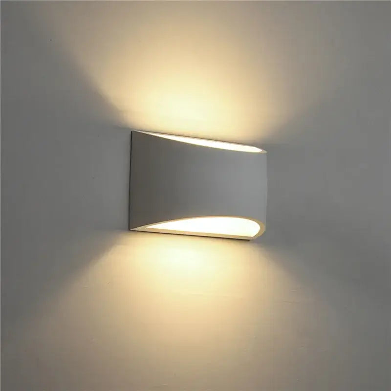 Minimalist white and gray gypsum wall lamp with sleek curved design and warm diffused light for living room