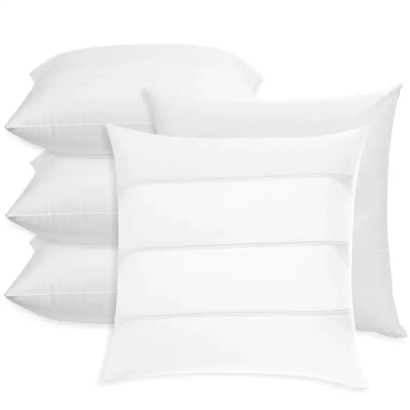 Set of four white inflatable pillow cores with minimalist design and subtle horizontal stitching for bedroom inserts