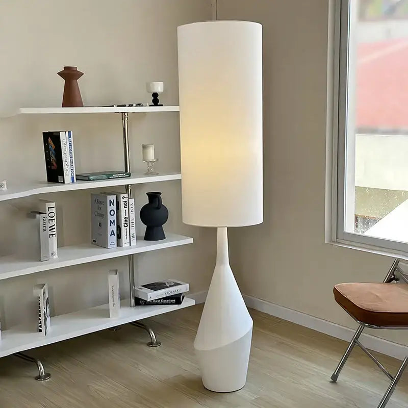 Minimalist white led floor lamp with a sculpted tapered base for modern living room lighting