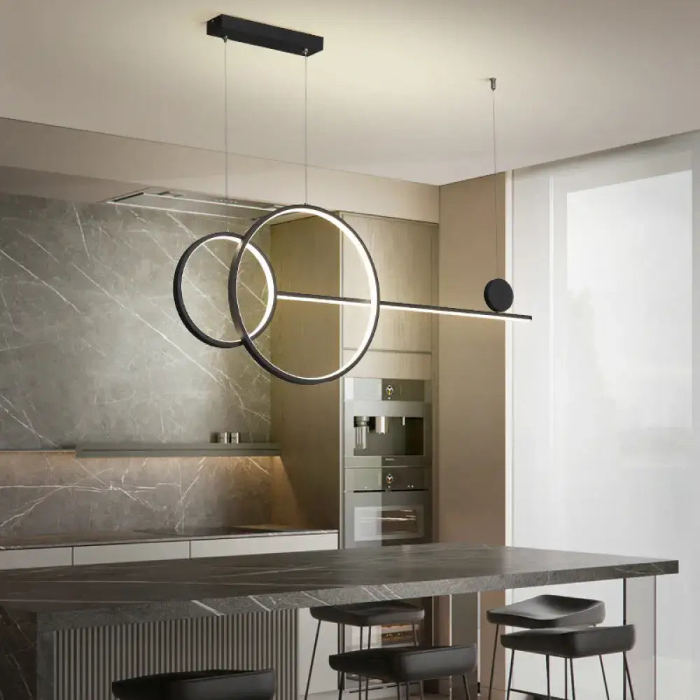 DecorBites sleek ring and linear led hanging lamp with black and gold metallic rings above kitchen island