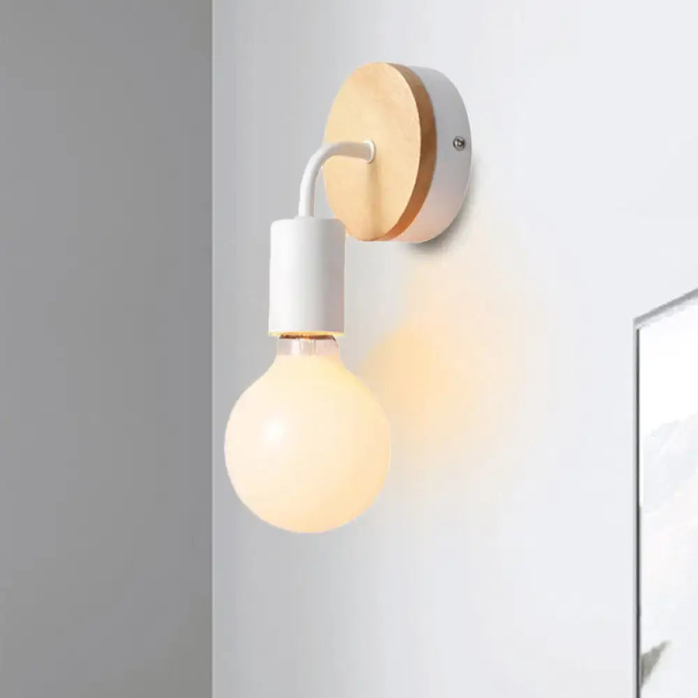 Minimalist white metal and wood bare bulb wall sconce with round wooden backplate and frosted glass bulb for bedroom light