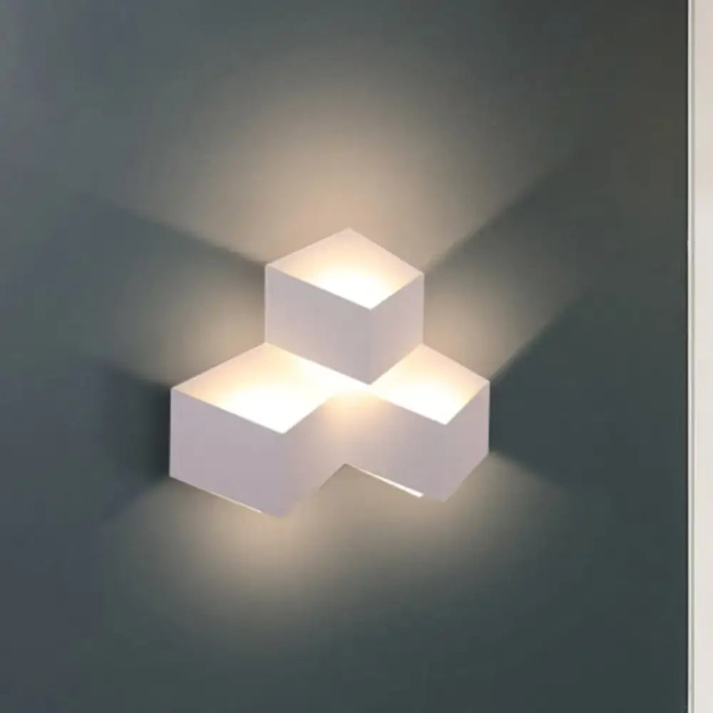 Minimalist white metallic geometric wall lamp with three illuminated cube sections for corridor wall mount lighting