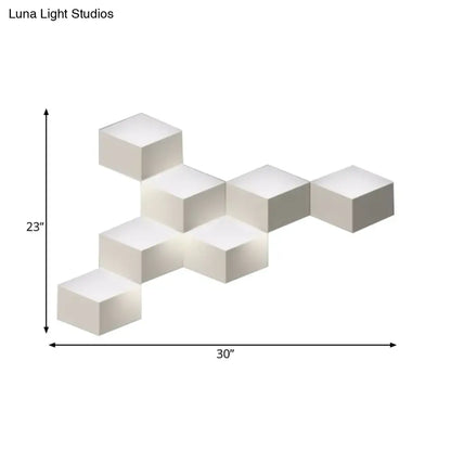 Minimalist white metallic geometric wall lamp with interconnected cubes designed as a geometric wall mount light for corridors