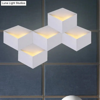 Minimalist white metallic geometric wall lamp with warm yellow illuminated cube design for corridor lighting