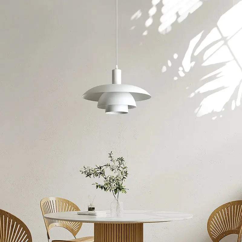 Minimalist white petal pendant light with layered shades suspended from a cord for dining room decorbites cream style