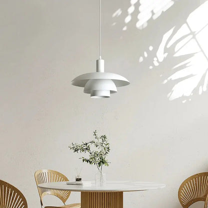 Minimalist white petal pendant light with layered shades suspended from a cord for dining room decorbites cream style