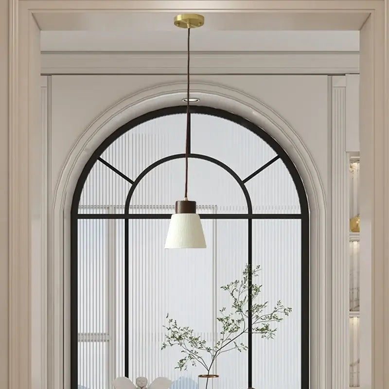 Minimalist white pleated glass pendant light with dark brown cord and metal fixture for dining room home decor by decorbites ceramic led