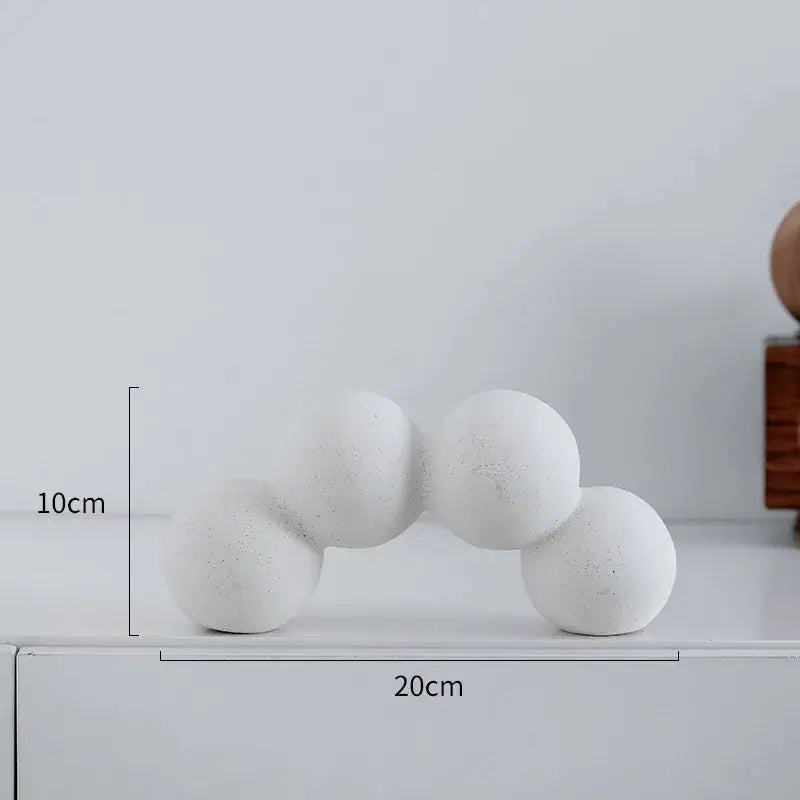 Minimalist white speckled geometric ceramic handicraft sculpture featuring a concrete arch with five interconnected spheres